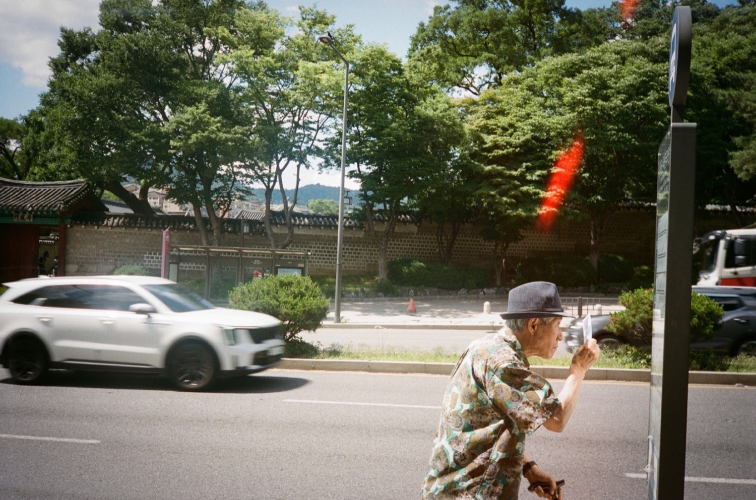Street scene with a pedestrian and passing car